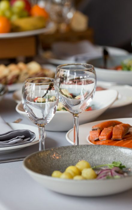 glasses and plates with snacks on the festive table in the restaurant. table setting