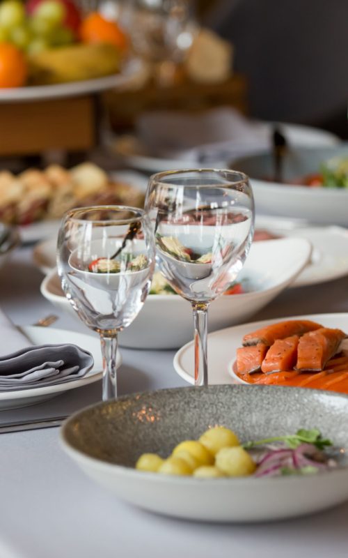 glasses and plates with snacks on the festive table in the restaurant. table setting
